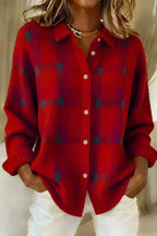 Red and grey checked knit shacket with pearl-style buttons and pointed collar, paired with white jeans