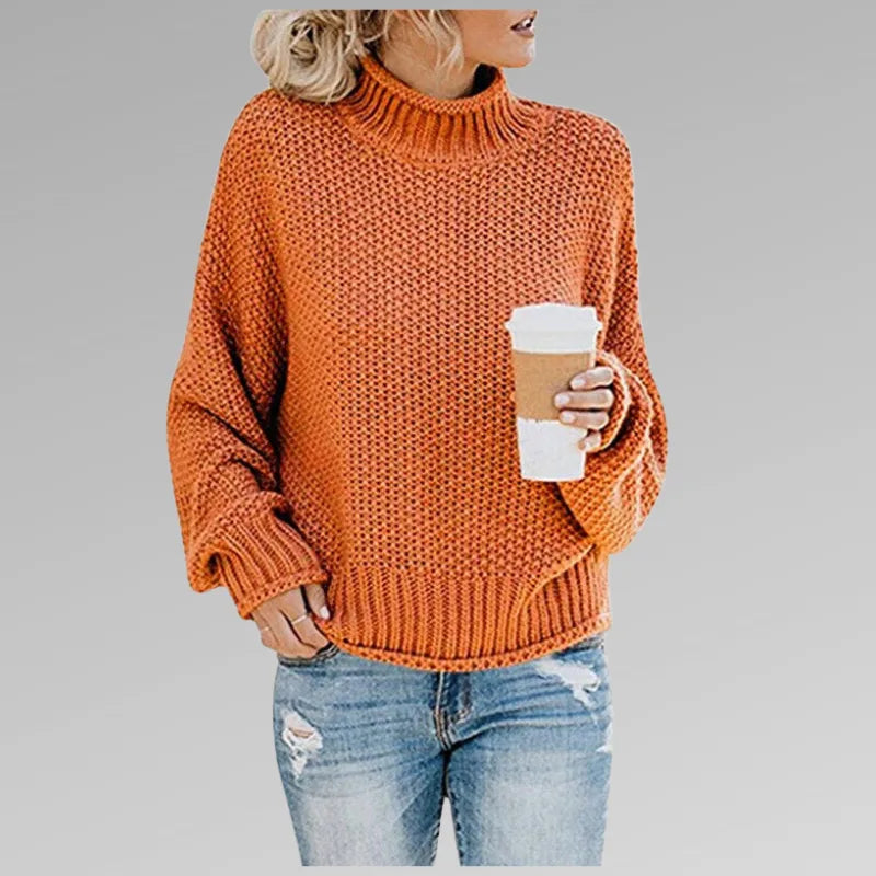 Orange chunky knit polo neck jumper with dropped shoulders and balloon sleeves, worn with ripped jeans