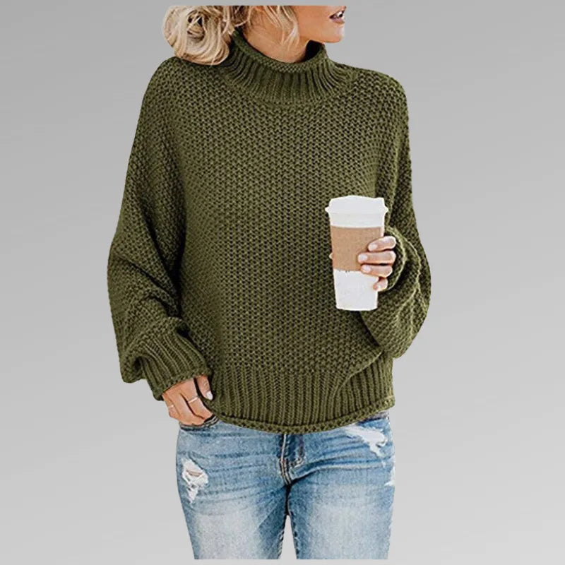 Olive green textured knit jumper with high polo neck, paired with distressed denim jeans