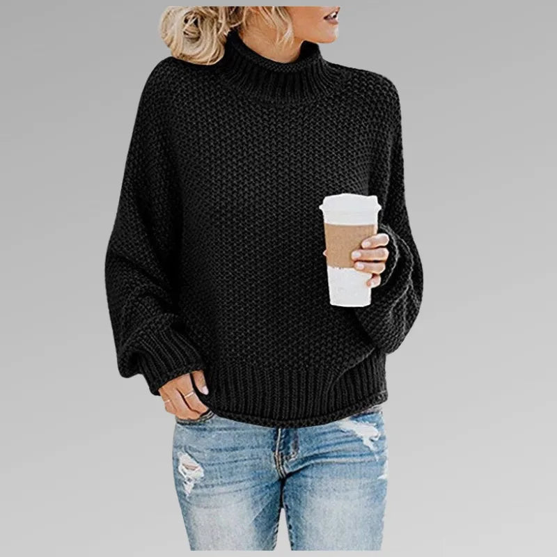 Black chunky knit oversized jumper with ribbed hem and polo neck, front view close-up
