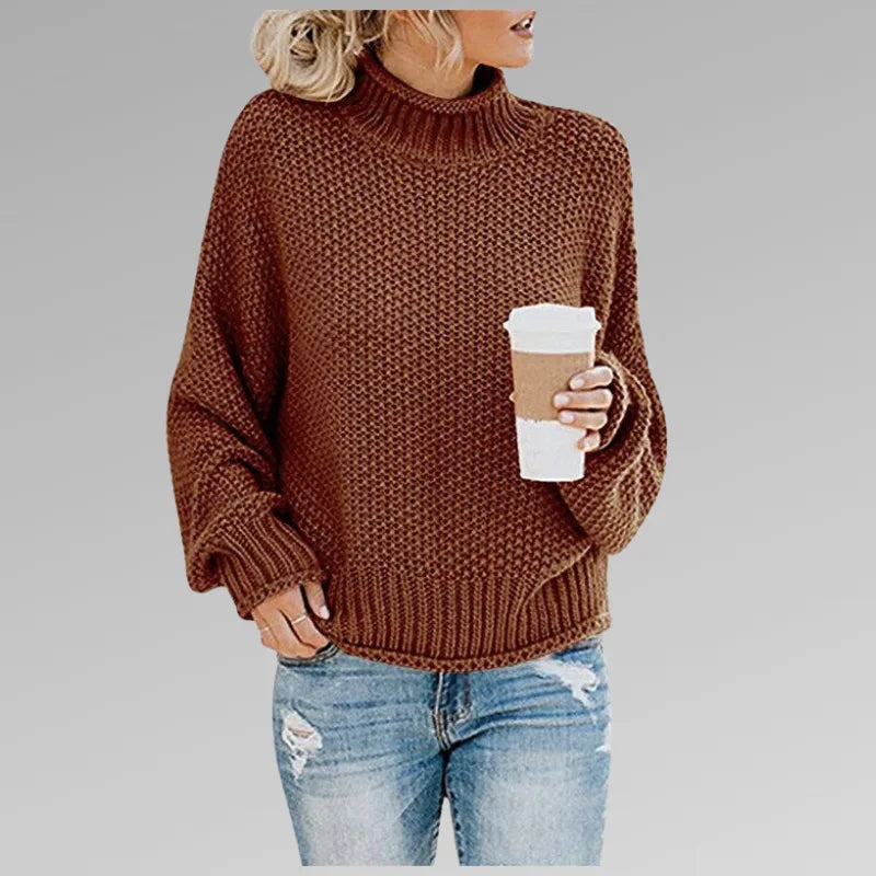 Rust brown textured knit jumper with balloon sleeves and ribbed cuffs, styled with ripped jeans