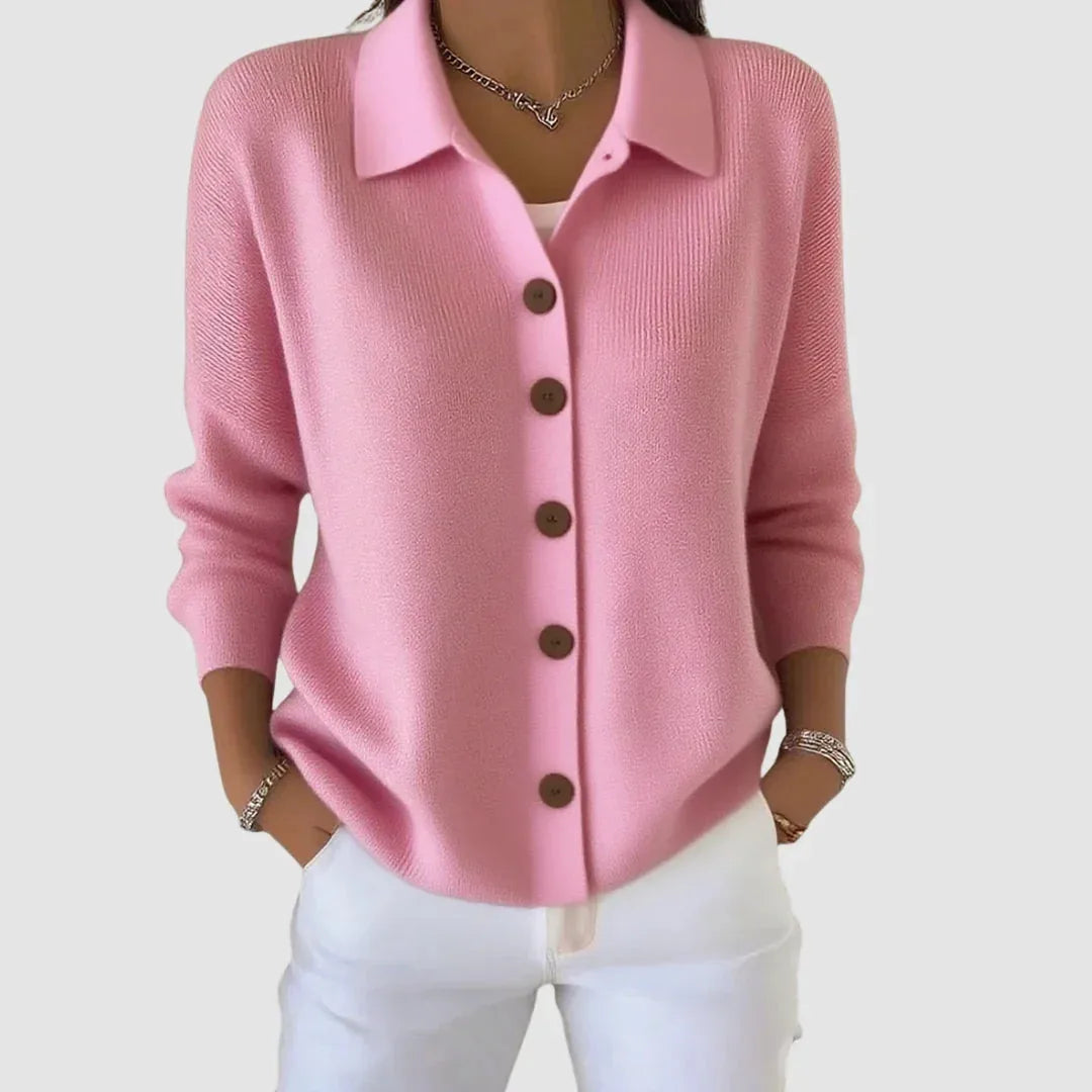 Soft pink knit cardigan with collared neckline and button-front closure, worn over a white top