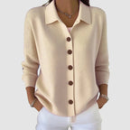Apricot cream knit cardigan with collared neckline and button-front, long sleeves with ribbed cuffs