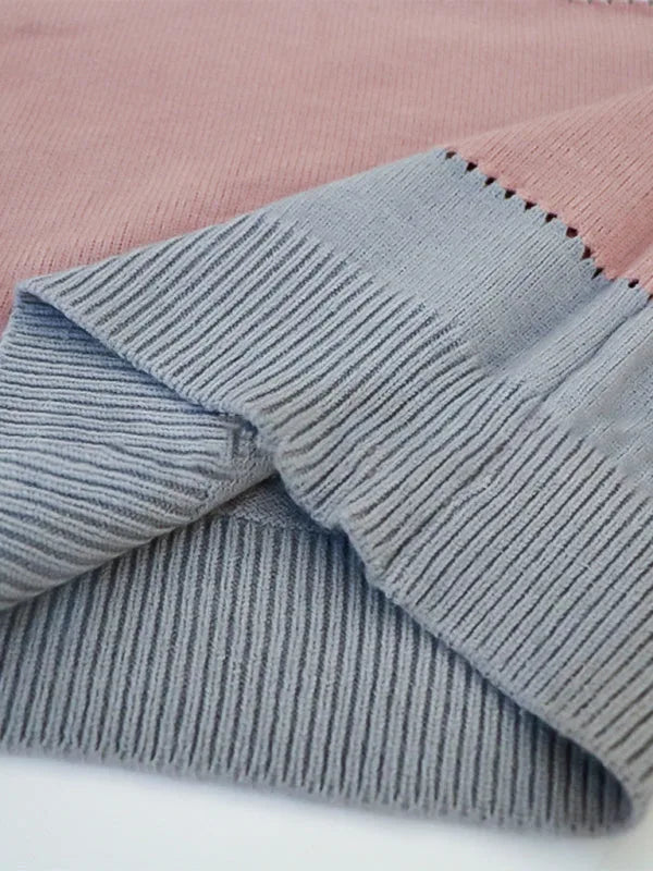 Close-up of the ribbed knit cuff detail in grey and dusty pink with contrast stitching