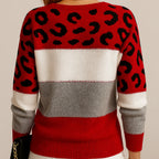 Back view of a red, white and grey striped jumper with black leopard print panels on the shoulders and sleeves