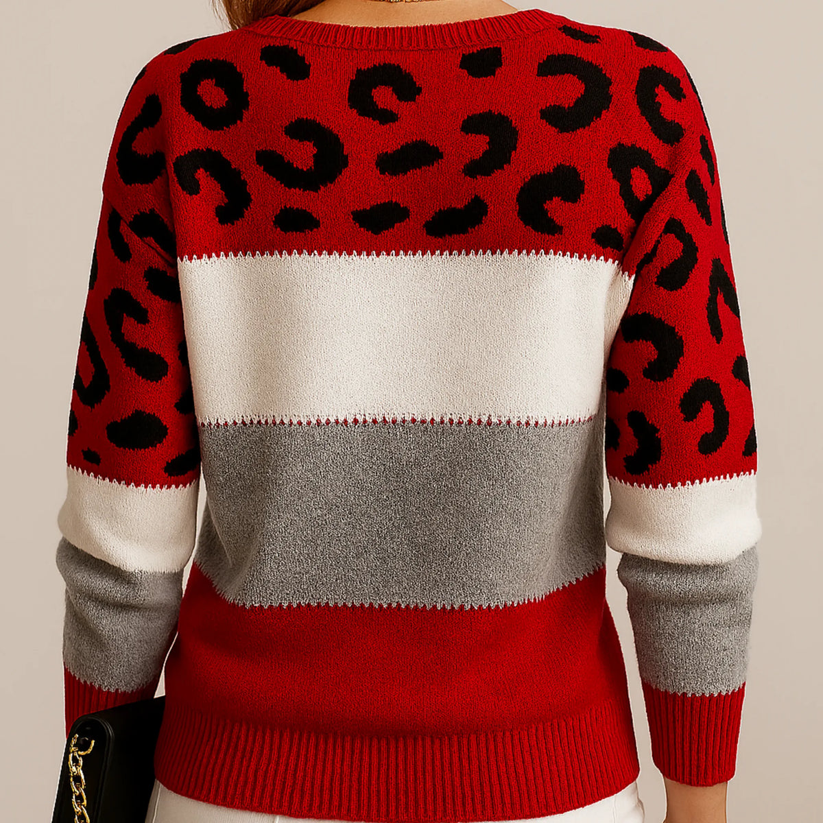 Back view of a red, white and grey striped jumper with black leopard print panels on the shoulders and sleeves