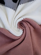 Close-up of the colour-block knit fabric in cream, grey and dusty pink showing the ribbed texture