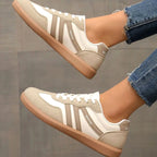 Overhead shot of black trainers crossed at the ankle with gum soles