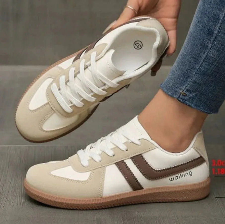 Side view of black trainer sole showing gum tread and stitched welt