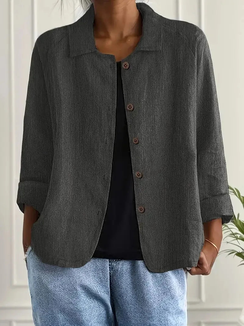 Close-up of the collar and neckline of a textured cotton-linen shirt jacket, buttons undone at top
