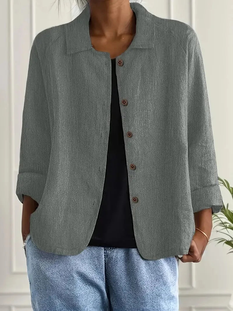 Close-up front view of a sage green textured cotton-linen shacket with dark button fastening and collared neckline