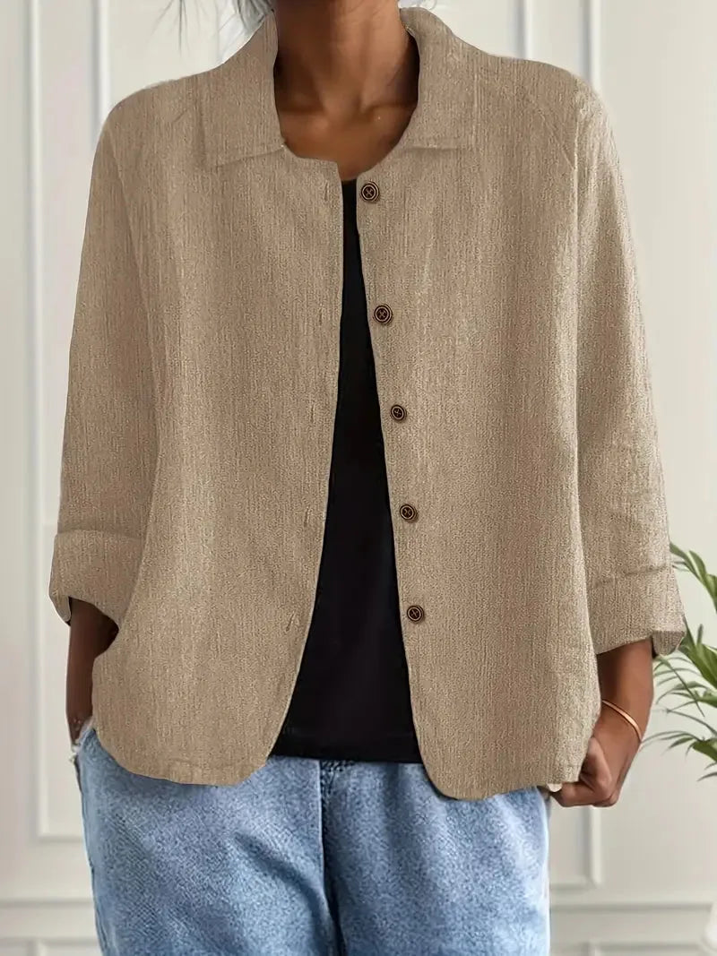 Warm khaki beige textured shirt jacket buttoned down the front with rolled three-quarter sleeves