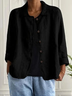 Black textured cotton-linen shirt jacket worn open, showing button placket and relaxed shoulder fit