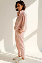 Side profile of the pink quarter-zip tracksuit set showing the relaxed fit and raised collar