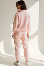 Back view of the pink tracksuit highlighting the drop-shoulder seam and straight-cut joggers