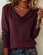Navy blue cowl neck jumper close-up showing the folded cowl collar and knit texture at the shoulders