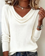Light grey cowl neck jumper paired with denim, close-up of the ribbed cuff and sleeve detail