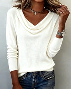 Brown cowl neck jumper styled with layered necklaces and a silver wristwatch