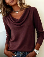 Dark purple cowl neck jumper paired with layered gold necklaces, showing the draped folded collar detail