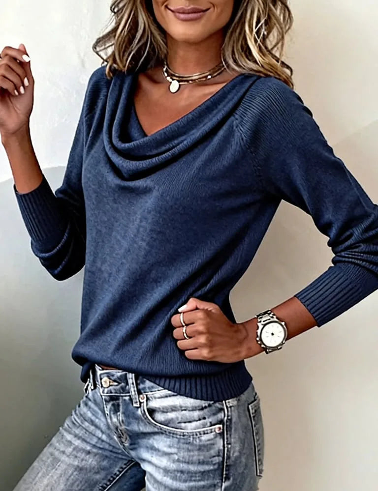Navy blue cowl neck jumper styled with denim, three-quarter view showing fit through the body