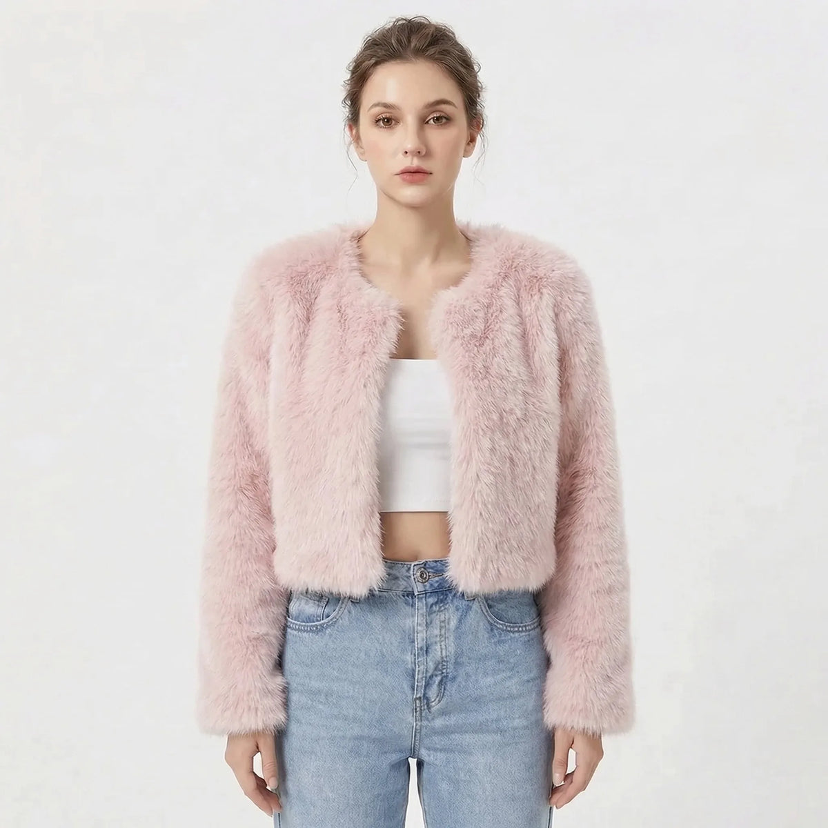 Cropped faux fur jacket in soft pink, open front collarless style, paired with denim jeans