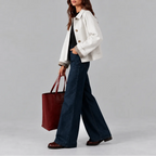 Side view of the white cropped jacket showing its structured collar and checked lining folded back at the sleeve