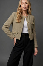 Full-length view of the tweed cropped jacket styled over black wide-leg trousers with a belt