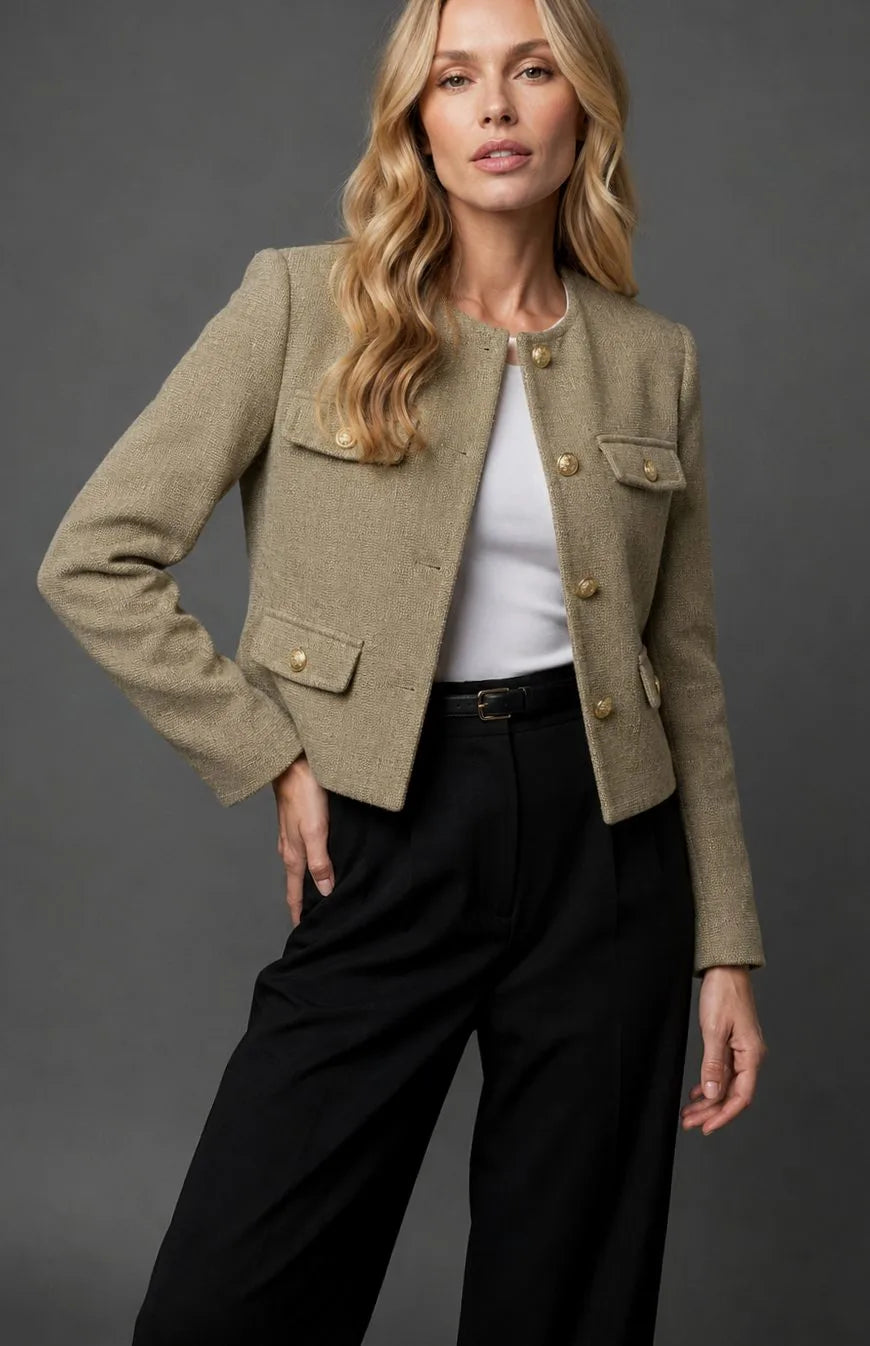Full-length view of the tweed cropped jacket styled over black wide-leg trousers with a belt