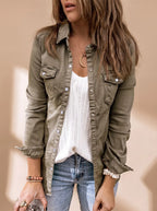 Angled front view of the olive green denim jacket highlighting the snap button placket and rolled-up sleeves