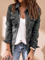 Close-up of the same style jacket in a dark charcoal grey denim wash worn over a white knit top