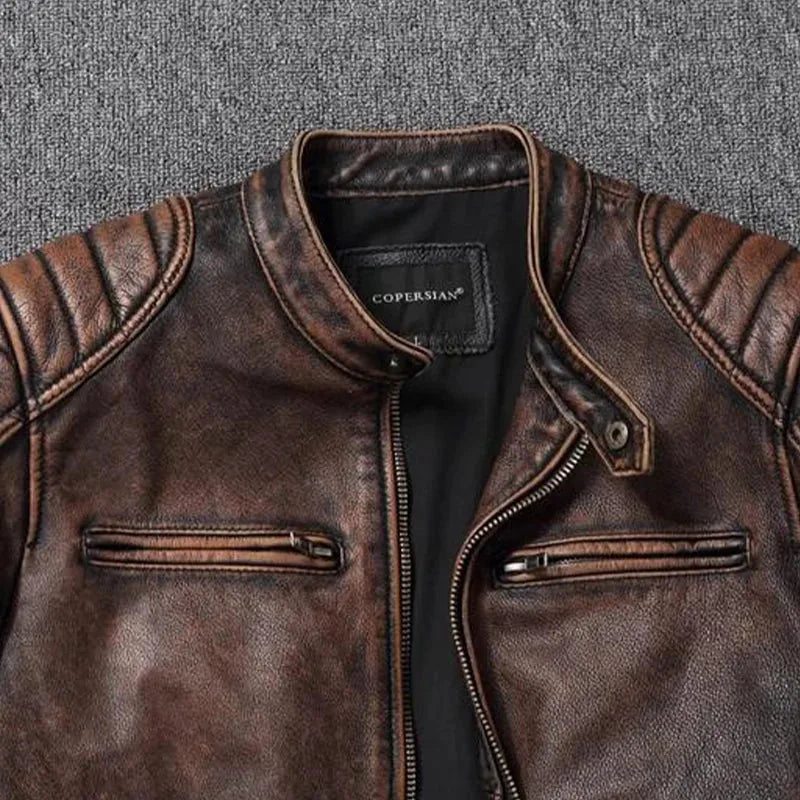 Close-up of stand collar with snap button and front zip on brown distressed leather jacket