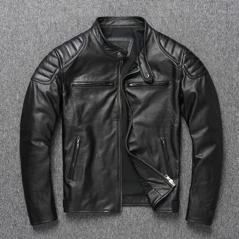 Black leather biker jacket laid flat, open to show black lining, zip pockets and quilted shoulders
