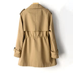 Back view of the hazelnut brown trench coat showing the raglan sleeves and gathered waist seam detail.