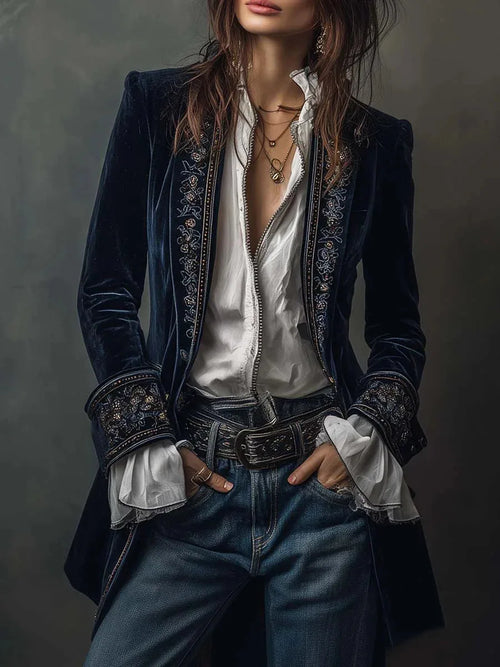 Front view of navy velvet jacket with embroidered lapels worn open over a white blouse and jeans