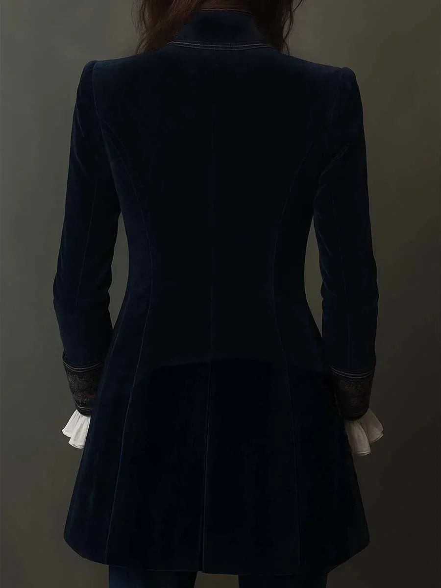 Back view of navy velvet jacket showing tailored fitted silhouette and flared hem