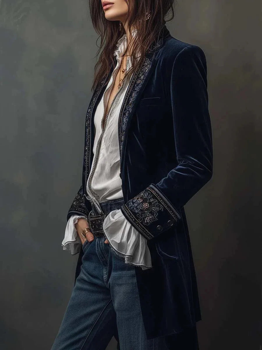 Side profile of navy velvet jacket highlighting embroidered cuff detail and stand collar