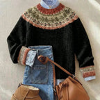 Black jumper with rust, olive and cream Fair Isle yoke and cuffs, layered over a striped collared shirt
