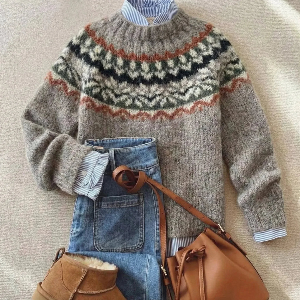Light grey knit jumper with a rust, black, green and cream patterned yoke and matching cuff trim