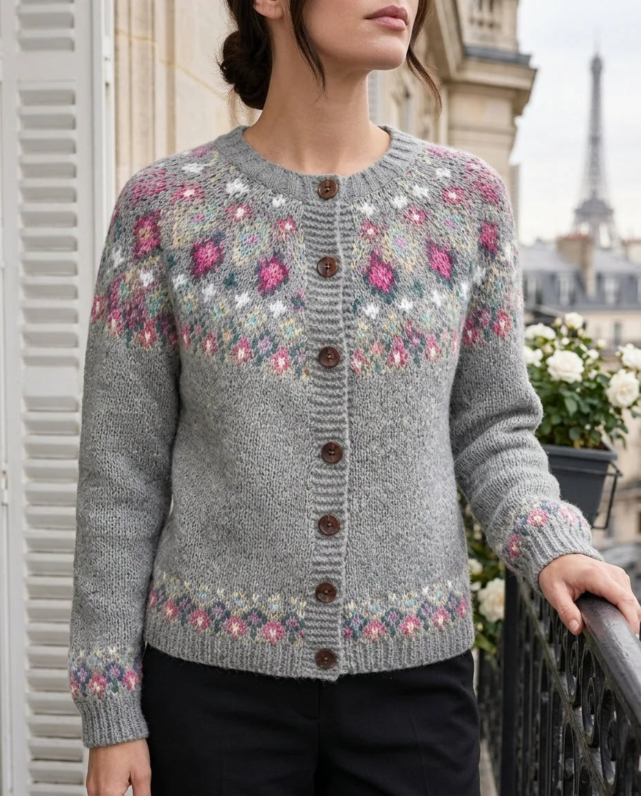 Close-up of a grey fair isle cardigan with pink, teal and cream diamond yoke pattern and dark wooden buttons down the front