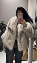 Close-up of the coat's cuff and sleeve showing the dense faux fur texture in black