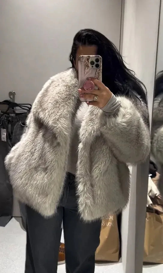 Close-up of the coat's cuff and sleeve showing the dense faux fur texture in black