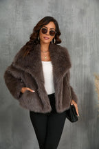 Close-up of the sleeve cuff and plush texture of the black faux fur coat in natural light