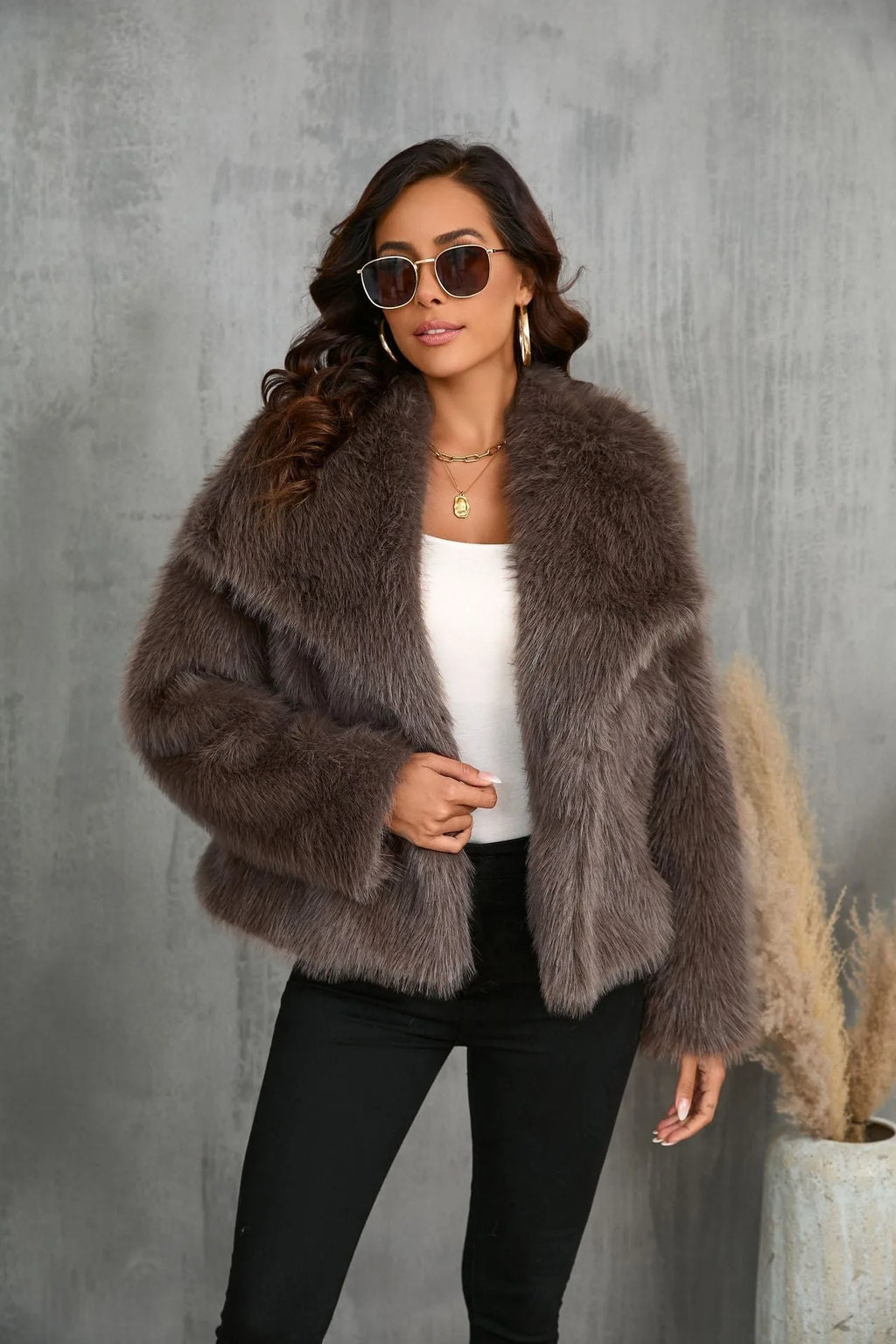 Close-up portrait showing the coat's collar framing the face with sunglasses and natural makeup