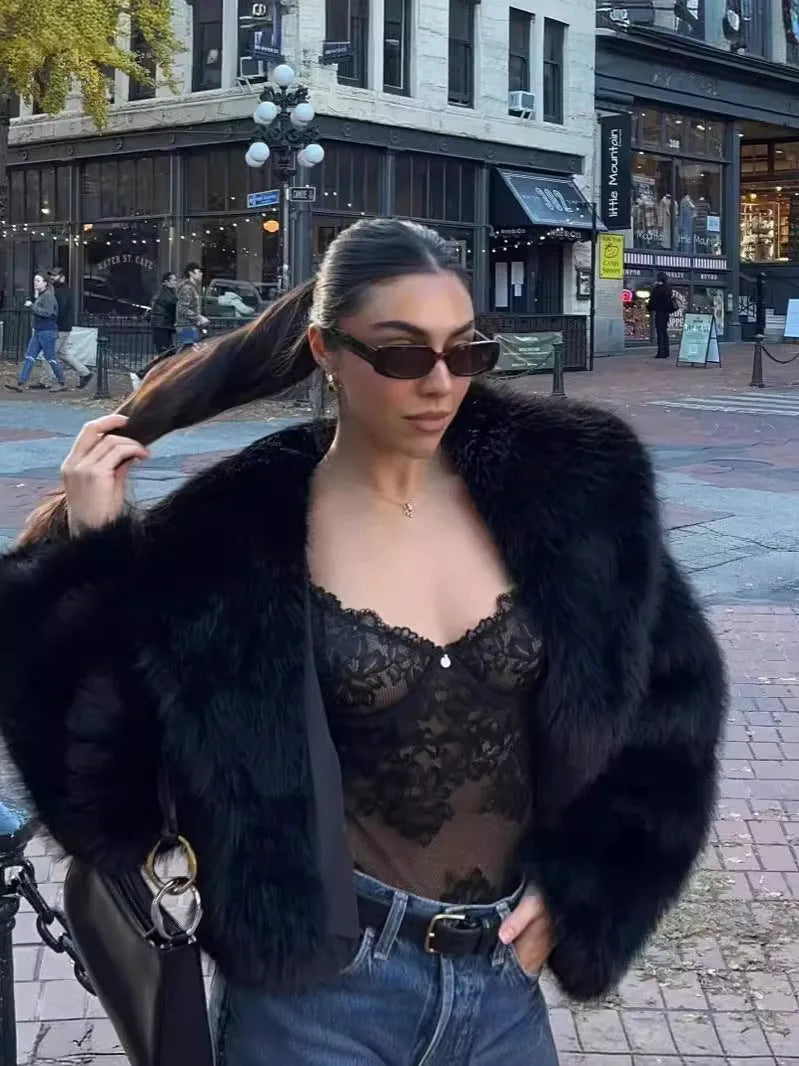 Close-up back and side view showing the texture and sleeve volume of the black faux fur coat
