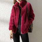 Deep burgundy faux fur jacket with stand collar and zip pull, styled with a dark leather crossbody bag