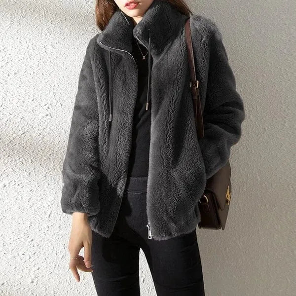 Charcoal grey faux fur jacket shown from the front, showing the boxy cropped fit and turtle collar