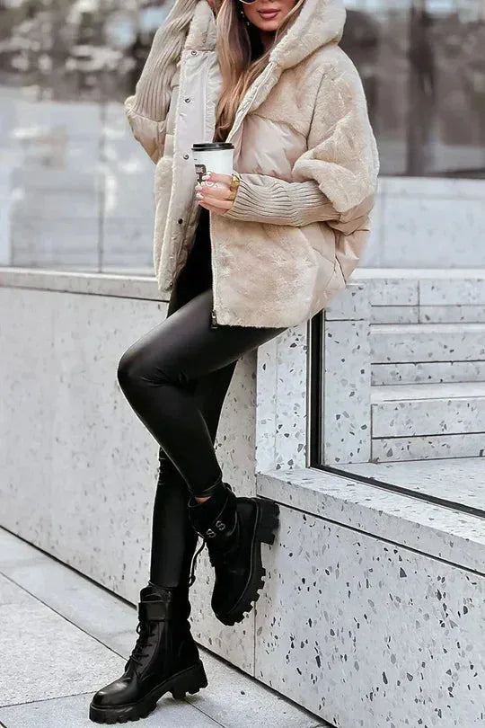 Beige puffer jacket worn with black leather leggings and lace-up combat boots, full length view