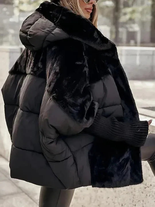 Black puffer jacket with faux fur sleeves and hood shown from the back, revealing quilted panelling