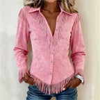 Close-up of pink faux suede fringe shirt with V-shaped yoke, snap buttons and fringed cuffs, worn open-collared