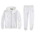 White full-zip hoodie and jogger tracksuit laid flat, showing navy embroidered logo and drawstring hood